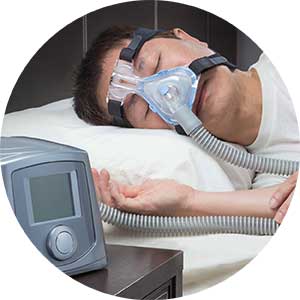 A man sleeps with the aid of a sleep apnea device