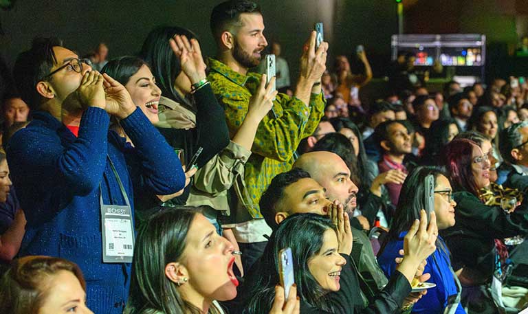 Audience members cheering at an event